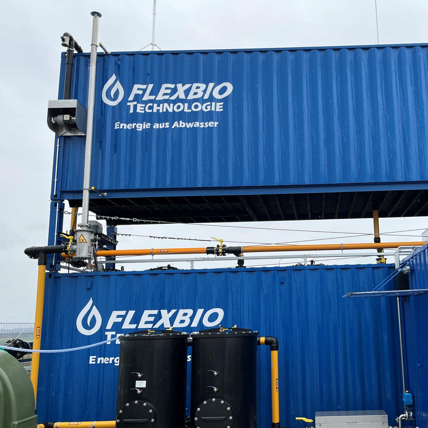 Elevated FlexBio biogas storage container above an anaerobic wastewater treatment plant, with pressure relief, gas piping, and gas purification.