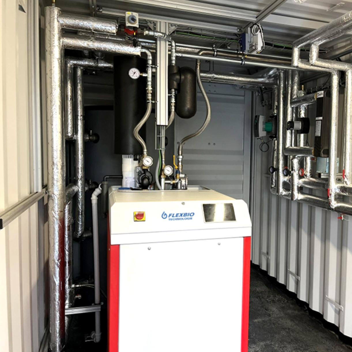 FlexBio CHP unit, 20 kWel, in a 20 ft HC container — plug-and-play solution for biogas utilisation with heating water buffer and control system.