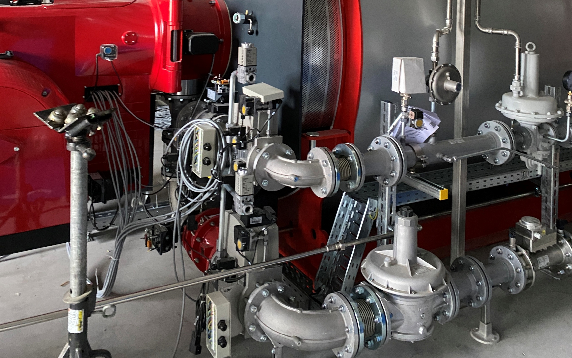 Part of a FlexBio-engineered Bosch boiler system with biogas burner, gas control line, and fittings for energy recovery from biogas — 1,200 kW thermal output.